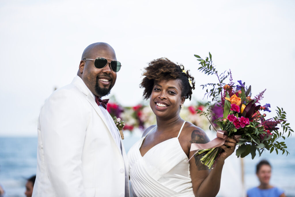 African American couple getting married at the beach